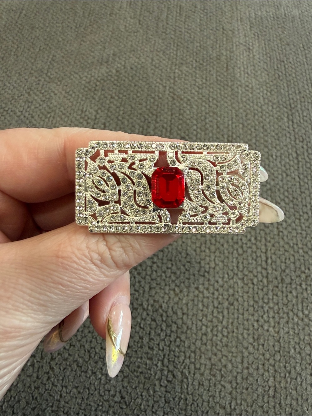 Elegant Silver-Tone Filigree Brooch with Red Center Stone